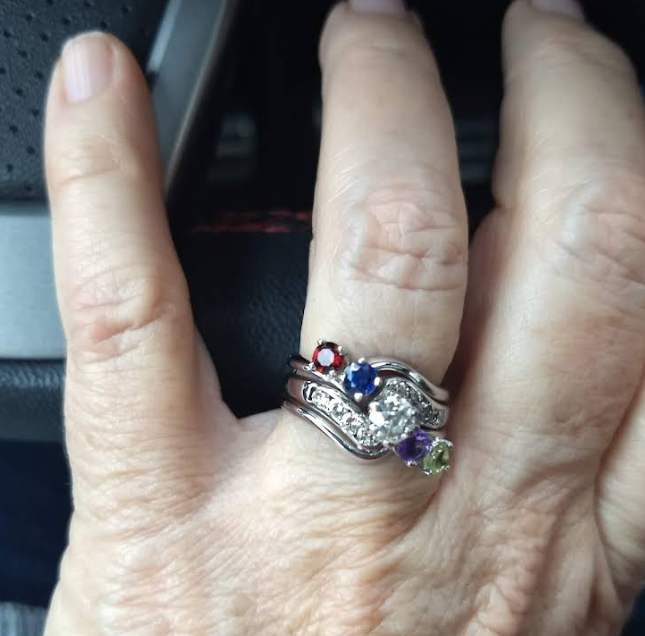 Custom mother's ring with multiple birthstones in a wave setting